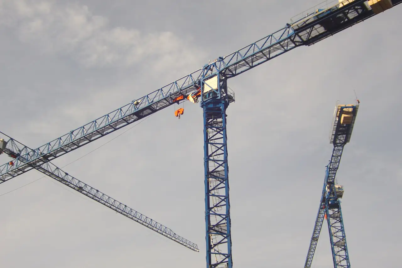 Tower crane jib and hook block against the sky